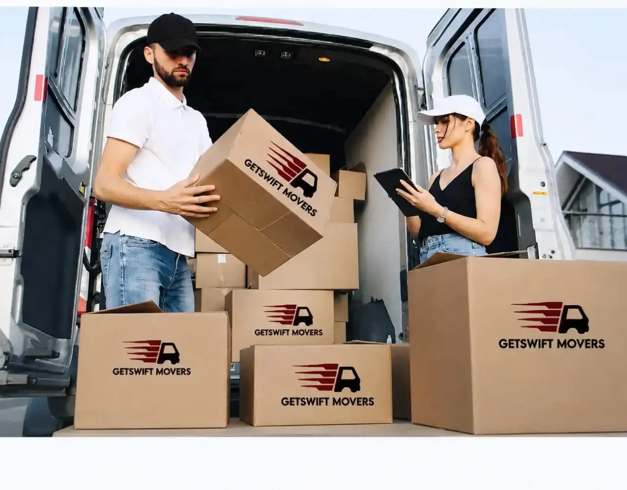Getswift Movers team loading boxes into a moving truck in Abu Dhabi